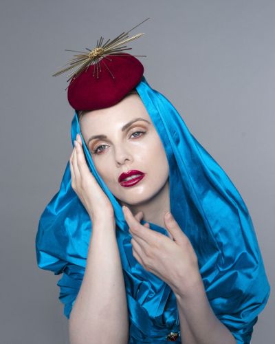 fashion model in eastern style blue headdress with dark red hat  