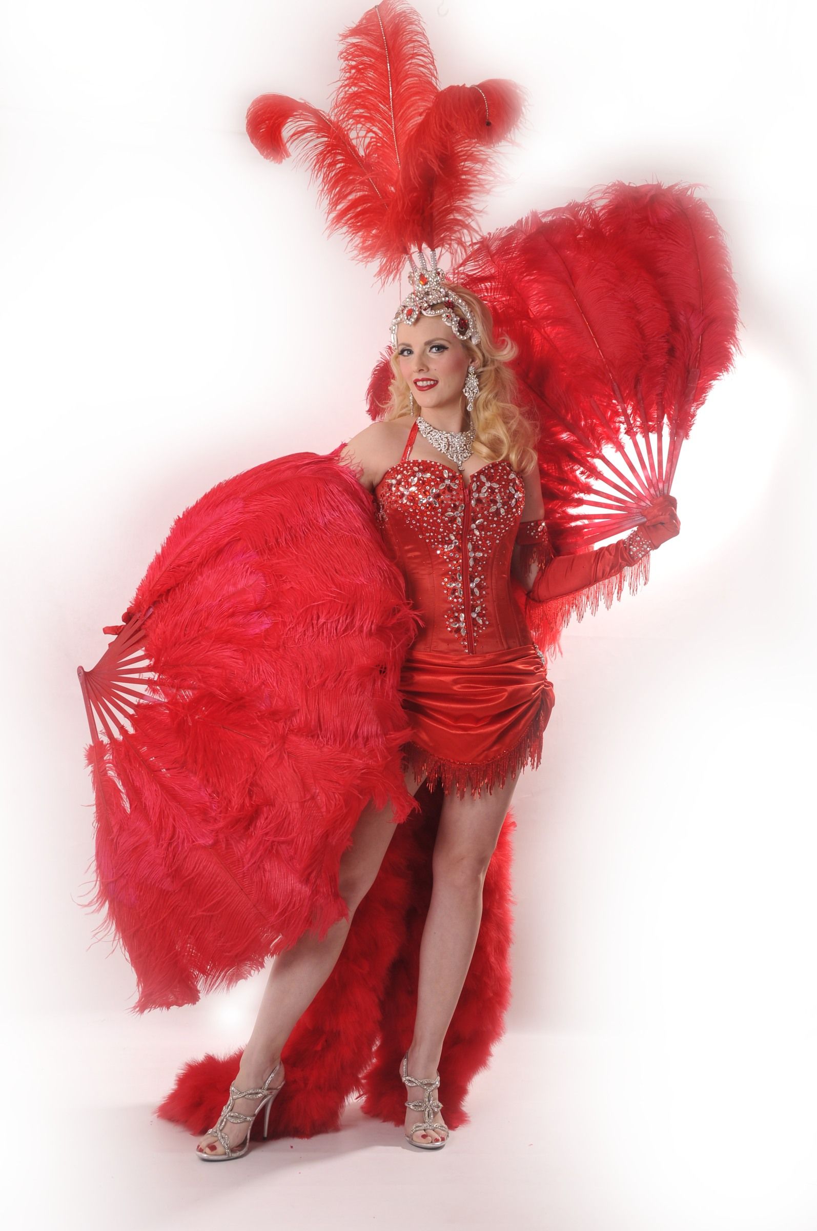 Moulin Rouge act red outfit holding large red feathered fans 