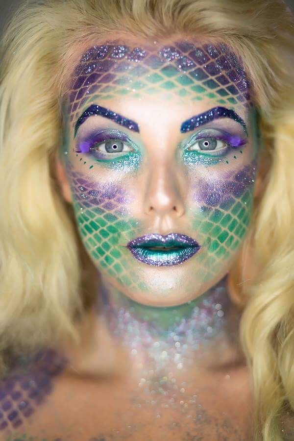 fashion model mermaid made up face in blue and green fish scales