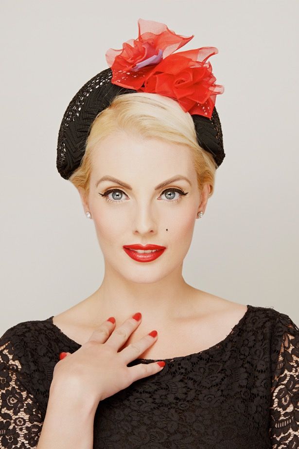 fashion model in black lace top and black hat with red lace trim