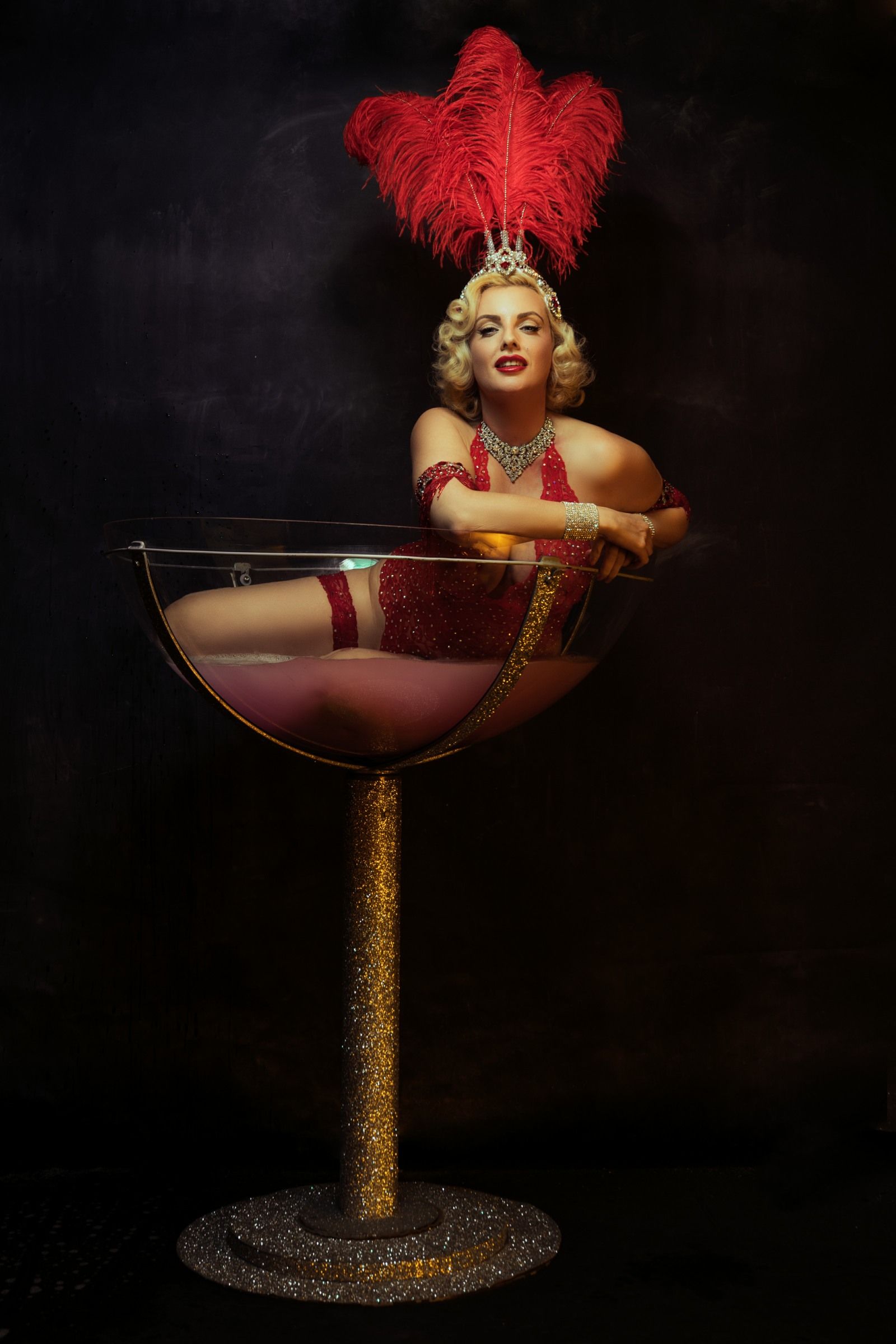 performing burlesque act in giant martini glass