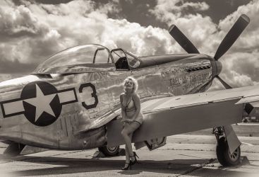 fashion model posing against american p51 mustang fighter
