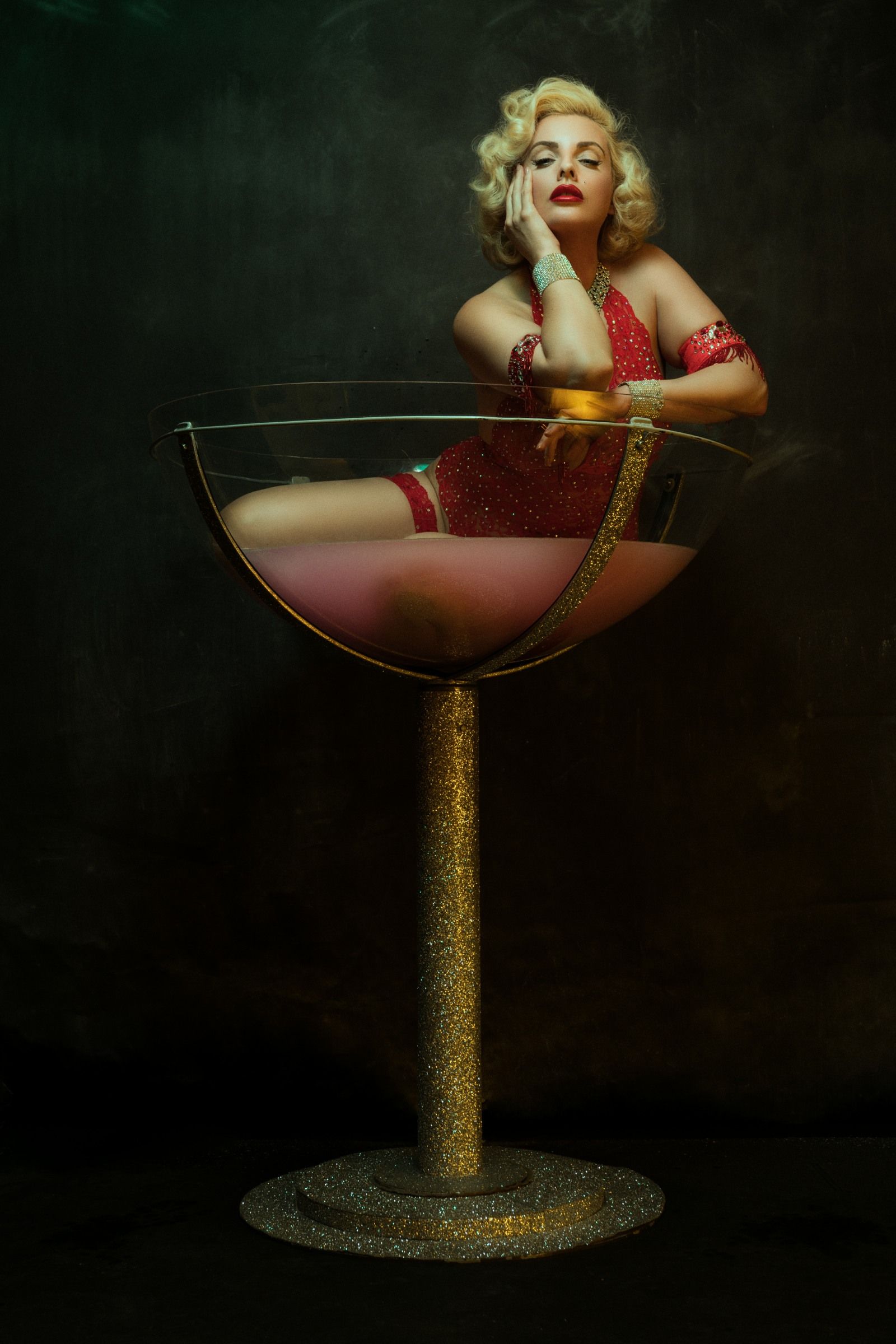 performing burlesque act in giant martini glass